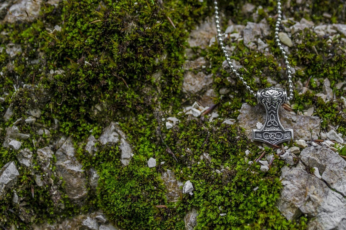 A viking necklaced placed on a mossy rock