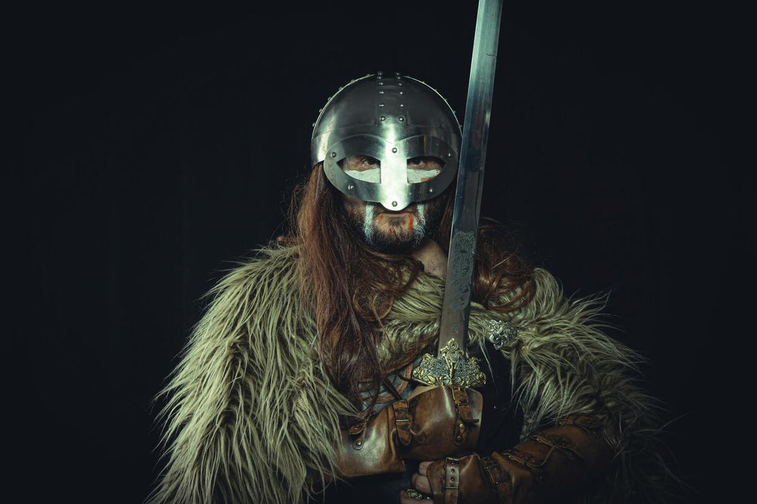 A viking wearing an armor and holding a sword with both hands