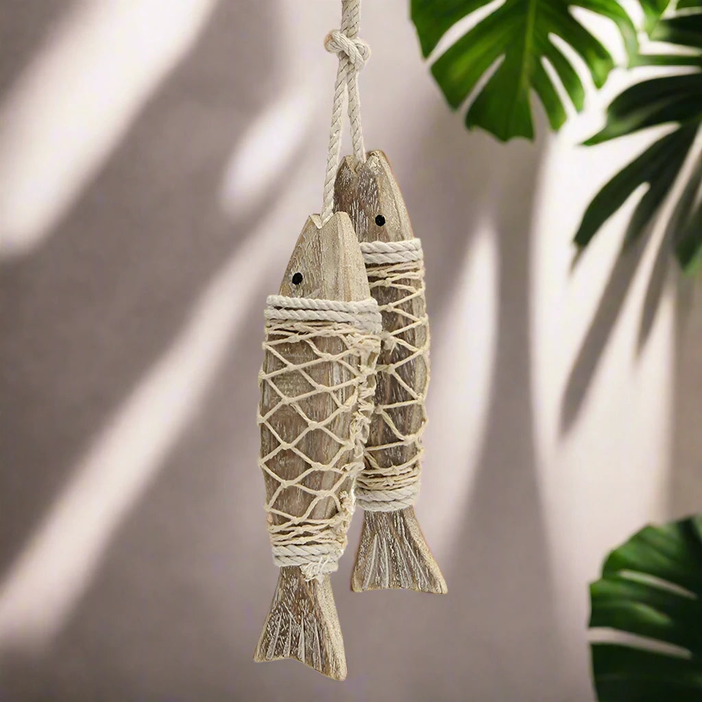 Two wooden fish hangings, ideal for viking decor enthusiasts